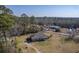 An aerial view of a charming single-Gathering home in a rural setting, surrounded by trees at 1186 French Santee Rd, Jamestown, SC 29453