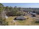 Aerial view showing the roof of the brick home, large lot, and surrounding trees at 1186 French Santee Rd, Jamestown, SC 29453