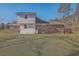 Backyard view of the house featuring a brick and white vinyl siding, with a grassy lawn at 1186 French Santee Rd, Jamestown, SC 29453