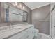Well-lit bathroom with double sinks, marble countertops, white cabinets, framed mirror, and tiled glass shower at 1186 French Santee Rd, Jamestown, SC 29453