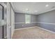 Empty bedroom with neutral carpet, gray walls, and white trim at 1186 French Santee Rd, Jamestown, SC 29453
