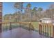 Back deck with brown railings, a grassy yard, and view of surrounding trees at 1186 French Santee Rd, Jamestown, SC 29453
