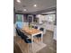 Open-concept dining room adjacent to a bright, modern kitchen with bar seating at 1186 French Santee Rd, Jamestown, SC 29453