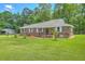 Charming brick home with a well-manicured lawn and mature trees at 1186 French Santee Rd, Jamestown, SC 29453