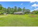Charming brick home with a well-manicured lawn and mature trees at 1186 French Santee Rd, Jamestown, SC 29453