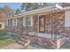 Close-up of brick-paved front porch with sturdy railing and decorative glass front door at 1186 French Santee Rd, Jamestown, SC 29453