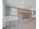 Bright living room with a brick fireplace, wood floors, large windows, wainscoting, and recessed lighting at 1186 French Santee Rd, Jamestown, SC 29453