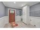 Mudroom with storage cabinet, wainscotting, tile floor, and access to the exterior at 1186 French Santee Rd, Jamestown, SC 29453
