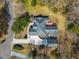 Overhead shot of a brick home, revealing its spacious layout, basketball court, and lush green surroundings at 121 Arrowridge Ct, Summerville, SC 29485