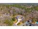 An aerial view shows this beautiful brick house nestled in a lush forest with a long driveway at 121 Arrowridge Ct, Summerville, SC 29485