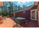 Outdoor deck features metal table and chairs plus wooded backyard views from the brick house at 121 Arrowridge Ct, Summerville, SC 29485