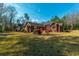 Brick house with a spacious backyard, red deck and lush green grass at 121 Arrowridge Ct, Summerville, SC 29485
