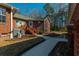 The backyard features a well-kept lawn, leading to the back entrance and exterior HVAC system, complete with tasteful landscaping at 121 Arrowridge Ct, Summerville, SC 29485