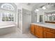 Bright bathroom with a large vanity, soaking tub, and glass-enclosed shower at 121 Arrowridge Ct, Summerville, SC 29485