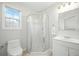 Bathroom featuring a glass-enclosed shower, white vanity, and a bright window at 121 Arrowridge Ct, Summerville, SC 29485
