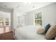 Cozy bedroom featuring a large window, closet with mirror doors, and access to outdoors at 121 Arrowridge Ct, Summerville, SC 29485