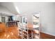 Bright dining room boasts wood floors, white walls, doors to deck, and seating for six at 121 Arrowridge Ct, Summerville, SC 29485