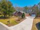Spacious red brick house with a long driveway leading to a detached garage at 121 Arrowridge Ct, Summerville, SC 29485