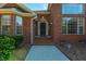 Inviting front entrance featuring a classic black door, brick facade, and mature landscaping, creating a warm welcome at 121 Arrowridge Ct, Summerville, SC 29485
