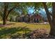 Charming red brick home with a well-manicured lawn, mature trees, and inviting curb appeal at 121 Arrowridge Ct, Summerville, SC 29485