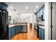 Well-equipped kitchen featuring stainless steel appliances, blue cabinetry, and hardwood floors, creating a stylish and functional space at 121 Arrowridge Ct, Summerville, SC 29485