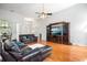 Spacious living room features hardwood floors, a ceiling fan, and a large media center at 121 Arrowridge Ct, Summerville, SC 29485