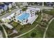 Aerial view shows a community pool surrounded by lush landscaping and residential homes, perfect for recreational activities at 1368 Clay Field Trl, Summerville, SC 29485