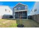 Expansive backyard view showcases a screened-in porch attached to a two-story home, ideal for relaxation and entertaining at 1368 Clay Field Trl, Summerville, SC 29485