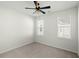Clean and spacious carpeted bedroom with a ceiling fan, windows, and fresh white walls at 1368 Clay Field Trl, Summerville, SC 29485