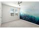 Bedroom with a nature-inspired mural wall, a ceiling fan, and large windows for natural light at 1368 Clay Field Trl, Summerville, SC 29485