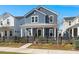 Attractive two-story home featuring blue siding, white trim, and a welcoming front porch with a black picket fence at 1368 Clay Field Trl, Summerville, SC 29485