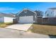 Front view of the detached garage with a wide driveway for convenient parking and easy access to the property at 1368 Clay Field Trl, Summerville, SC 29485
