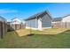 Detached garage in backyard with its own door, set off by a wooden fence, offering extra storage and convenience at 1368 Clay Field Trl, Summerville, SC 29485