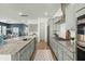 Elegant kitchen with gray cabinets, granite countertops, and stainless-steel appliances in an open layout at 1368 Clay Field Trl, Summerville, SC 29485