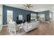 Spacious living room with stylish furniture, blue accent wall, and dining area in background at 1368 Clay Field Trl, Summerville, SC 29485
