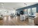 Spacious living room with hardwood floors, a dining area, and large windows for ample natural light at 1368 Clay Field Trl, Summerville, SC 29485