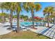 Inviting community pool area with palm trees and shaded seating, perfect for relaxation and social gatherings at 1368 Clay Field Trl, Summerville, SC 29485