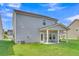 Home exterior features a well-maintained lawn and a covered back patio at 141 Woodland Oak Way, Summerville, SC 29485