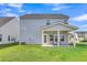 Home exterior features a well-maintained lawn and a covered back patio at 141 Woodland Oak Way, Summerville, SC 29485