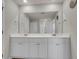 Bright bathroom features a double sink vanity with large mirror and white cabinets at 141 Woodland Oak Way, Summerville, SC 29485