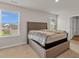 Well-lit bedroom with queen bed, carpeted floor, and three windows for natural light at 141 Woodland Oak Way, Summerville, SC 29485