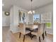 Bright dining room featuring large table, upholstered chairs, chandelier, and natural light at 141 Woodland Oak Way, Summerville, SC 29485