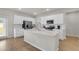 Well-lit kitchen with stainless steel appliances, white cabinets, a kitchen island and ample counter space for meal preparation at 141 Woodland Oak Way, Summerville, SC 29485