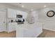 Modern kitchen with white cabinets, stainless steel appliances, and a central island with a sink, offering ample counter space at 141 Woodland Oak Way, Summerville, SC 29485