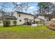 A spacious backyard featuring a patio, green grass, and mature trees at 159 Bridgecreek Dr, Goose Creek, SC 29445