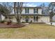 Charming two-story home featuring a welcoming front porch with green shutters and complemented by mature trees at 159 Bridgecreek Dr, Goose Creek, SC 29445
