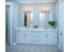 Bright bathroom featuring double sinks, white cabinets, and patterned floor tiles at 1680 Siloh Dr # 469, Mount Pleasant, SC 29466