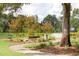 Scenic park view featuring walking paths, green spaces, a water feature, benches, and mature trees at 1680 Siloh Dr # 469, Mount Pleasant, SC 29466