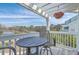 Cozy balcony with a round table and chairs, offering a peaceful outdoor retreat with scenic water views at 1717 Brittlebush Ln, Johns Island, SC 29455