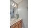 Clean bathroom with wooden vanity, decorative mirror and modern lighting at 1717 Brittlebush Ln, Johns Island, SC 29455